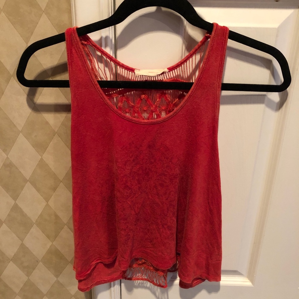 red tank top with design on front and string back